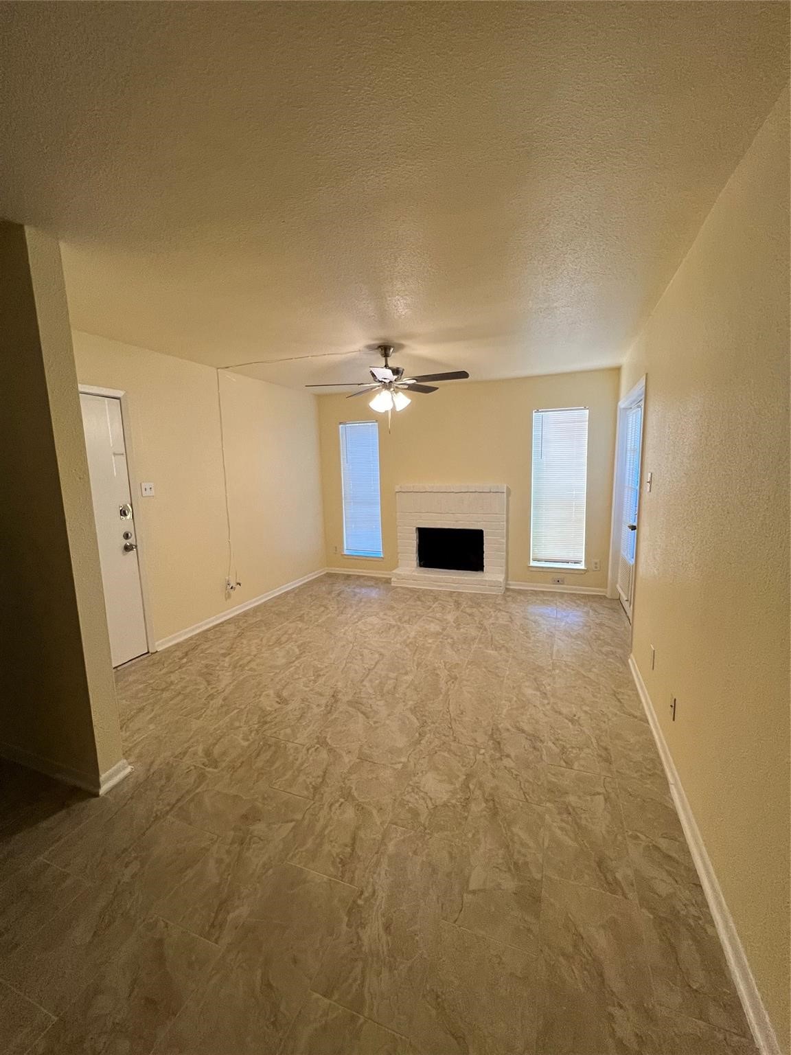 9000 Bissonnet Street, Unit 705 Houston, TX 77074 - Photo 6 of 18 a view of empty room with a fireplace