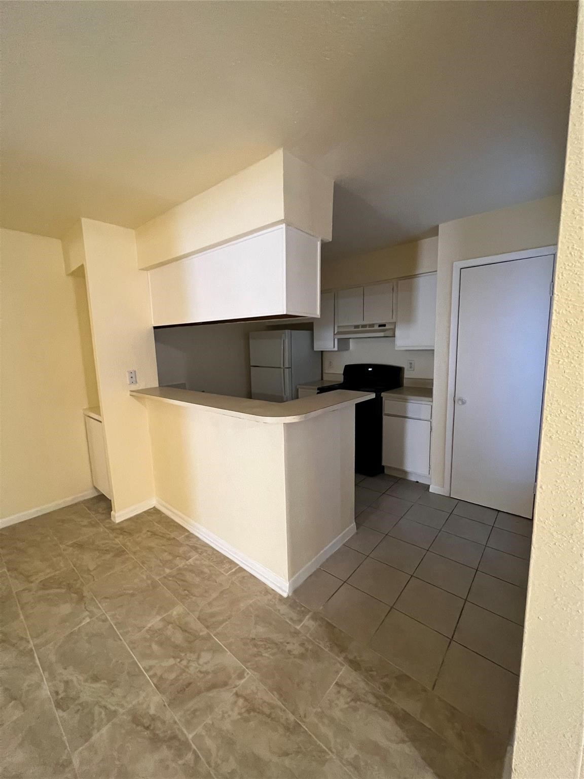 9000 Bissonnet Street, Unit 705 Houston, TX 77074 - Photo 8 of 18 a kitchen with stainless steel appliances a refrigerator and a stove top oven