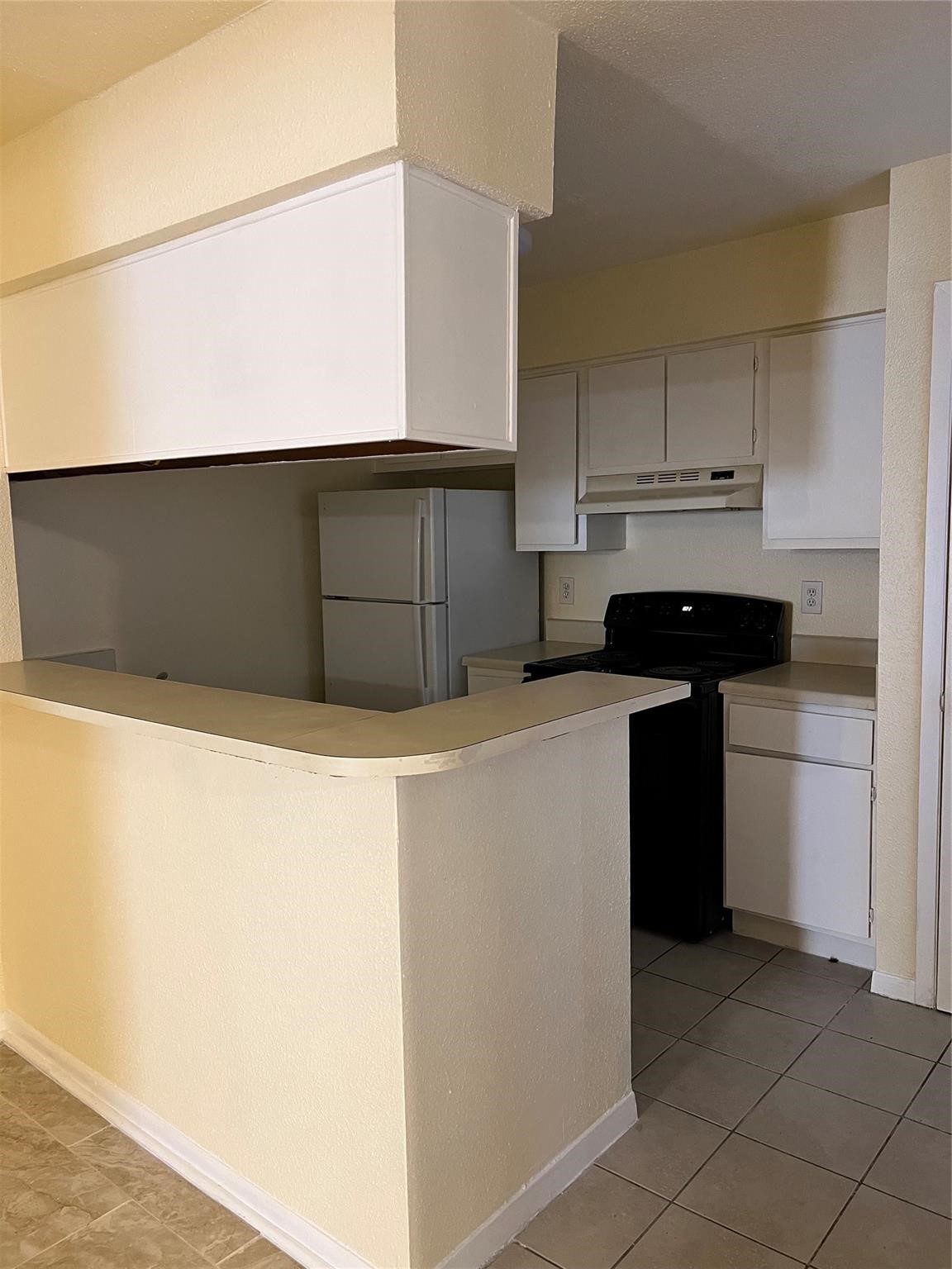 9000 Bissonnet Street, Unit 705 Houston, TX 77074 - Photo 9 of 18 a kitchen with kitchen island sink and cabinets