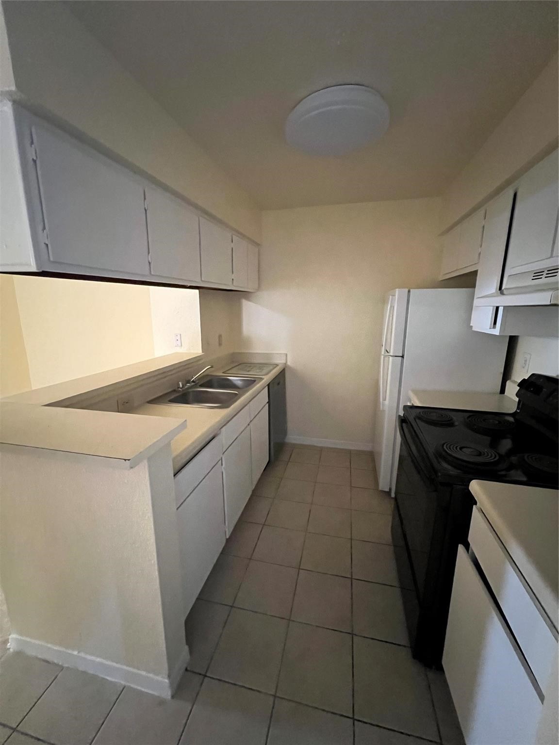 9000 Bissonnet Street, Unit 705 Houston, TX 77074 - Photo 10 of 18 a kitchen with a sink a stove and cabinets