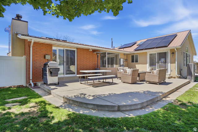 114 North Clark Lane Elk Ridge, UT 84651 - Photo 24 of 26 Expansive concrete patio with curved edges and a stucco and brick exterior