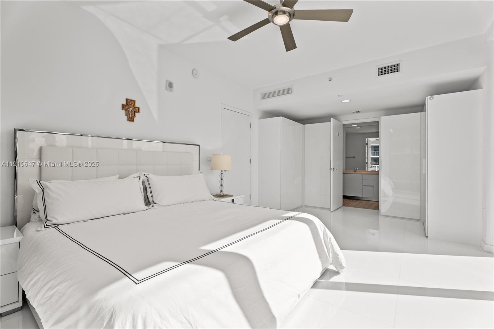 1010 Brickell Avenue, Unit 4206 Miami, FL 33131 - Photo 11 of 33 a spacious bedroom with a bed and cabinets