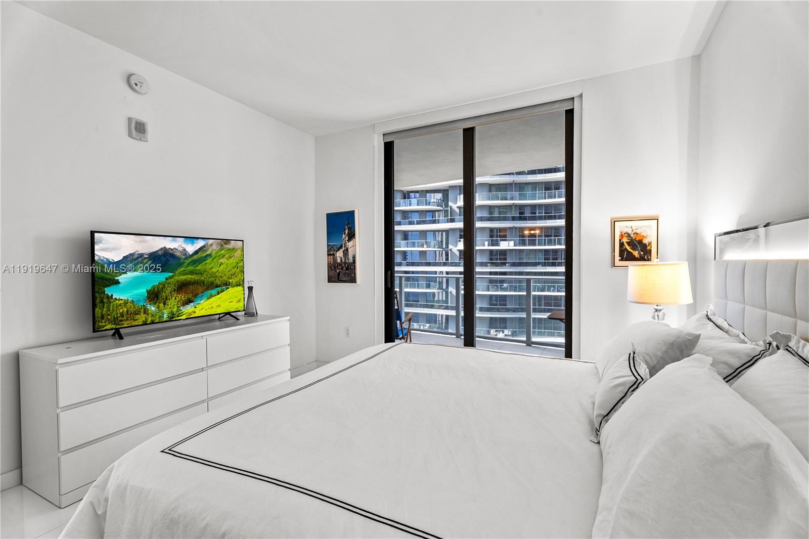 1010 Brickell Avenue, Unit 4206 Miami, FL 33131 - Photo 14 of 33 a bedroom with a bed and a flat screen tv