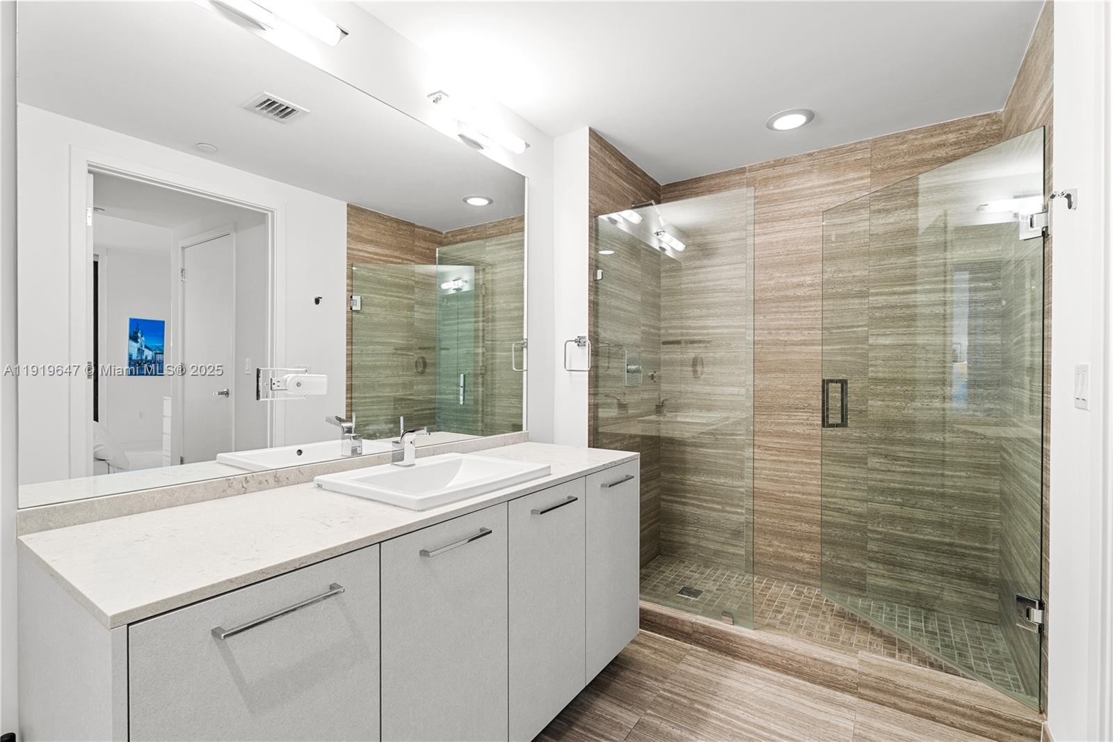 1010 Brickell Avenue, Unit 4206 Miami, FL 33131 - Photo 16 of 33 a bathroom with a sink shower and a mirror