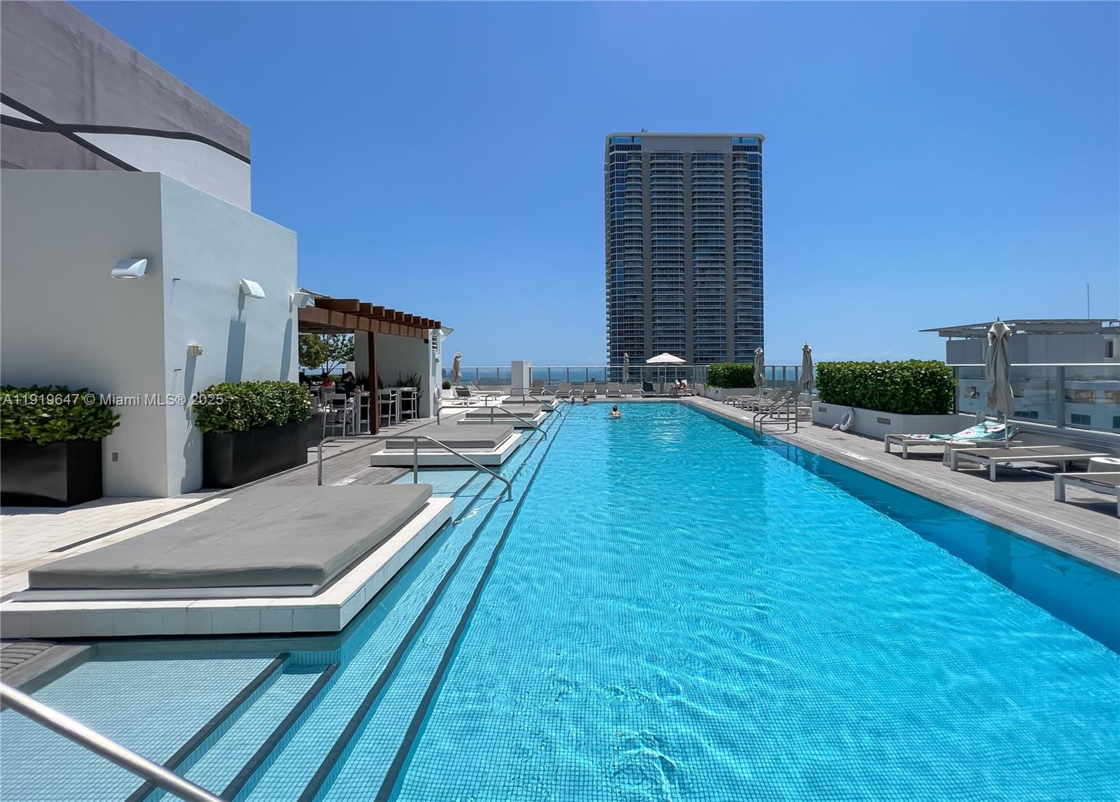 1010 Brickell Avenue, Unit 4206 Miami, FL 33131 - Photo 27 of 33 a swimming pool with outdoor seating and yard
