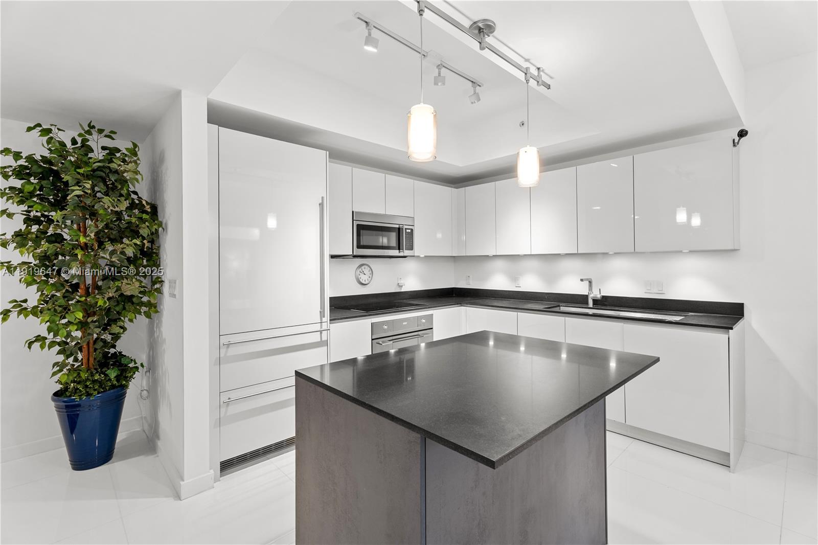 1010 Brickell Avenue, Unit 4206 Miami, FL 33131 - Photo 8 of 33 a kitchen with a sink a counter space stainless steel appliances and cabinets