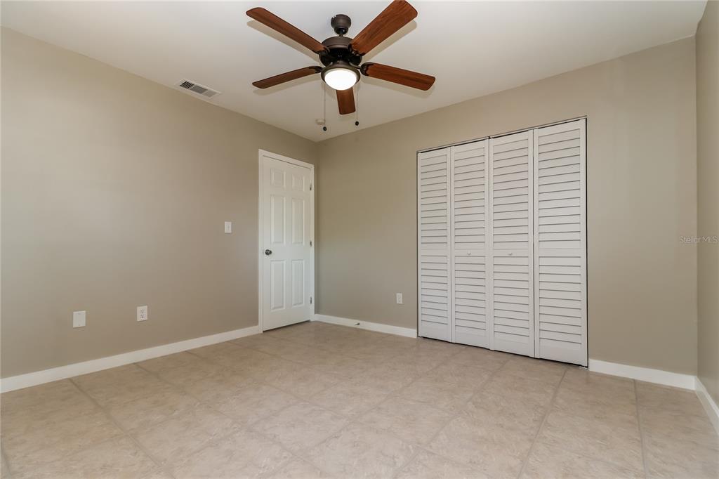 9537 Groveland Street Seminole, FL 33772 - Photo 11 of 16 an empty room with closet and fan
