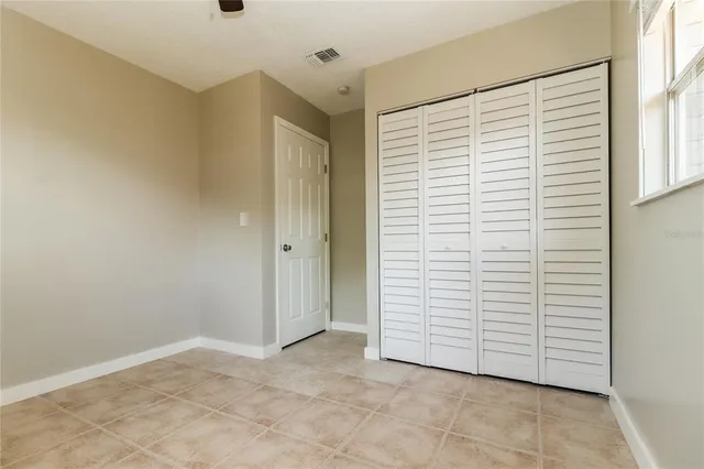 a view of a room with an empty space and a window