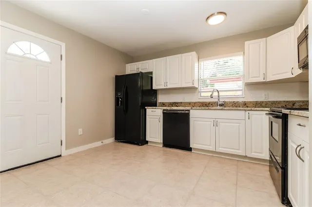 a kitchen with a sink stove and refrigerator