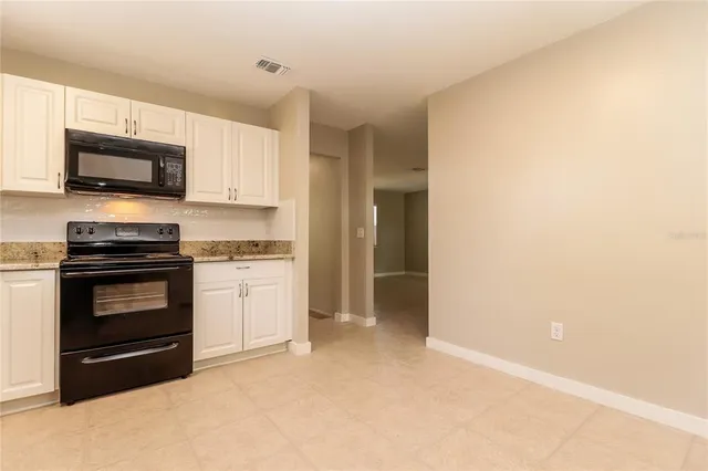 a kitchen with stainless steel appliances white cabinets and a stove