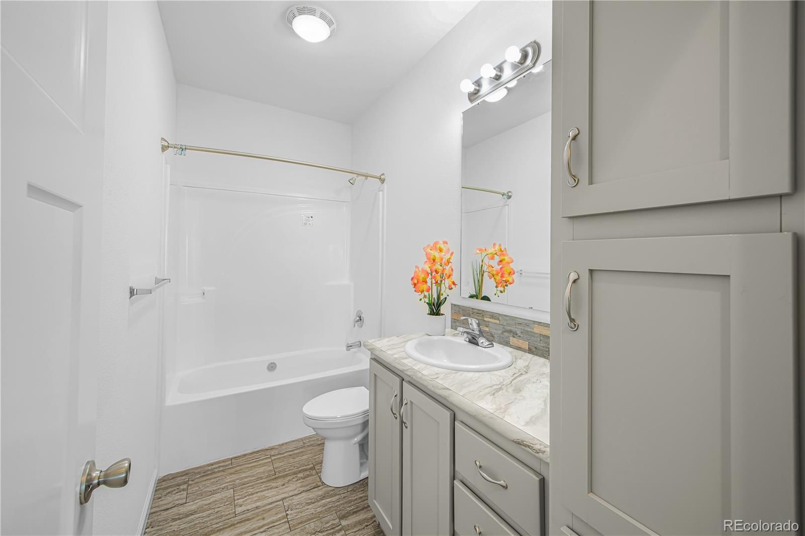 6 Timberlake Road Byers, CO 80103 - Photo 12 of 18 a bathroom with a granite countertop sink toilet and shower