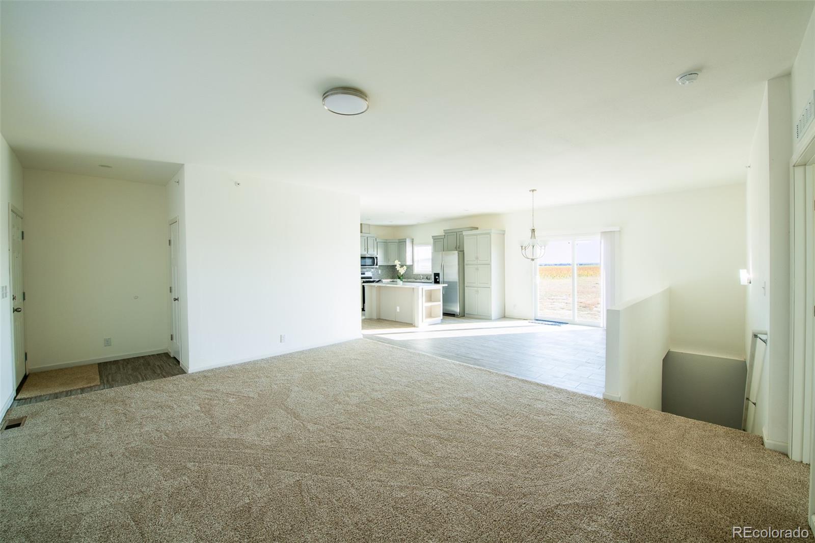 6 Timberlake Road Byers, CO 80103 - Photo 6 of 18 a view of empty room with a kitchen