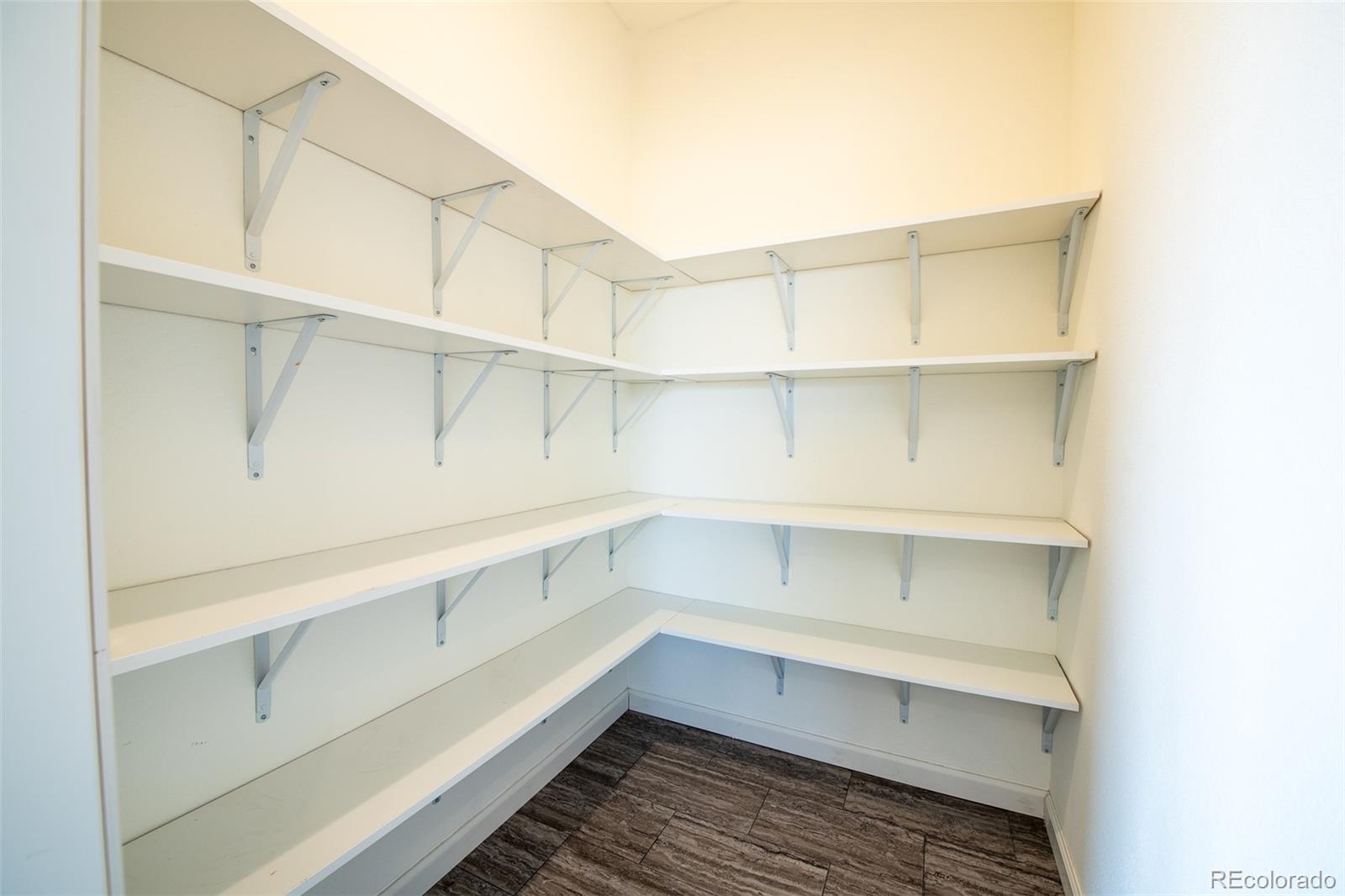 6 Timberlake Road Byers, CO 80103 - Photo 8 of 18 a storage room with cabinets