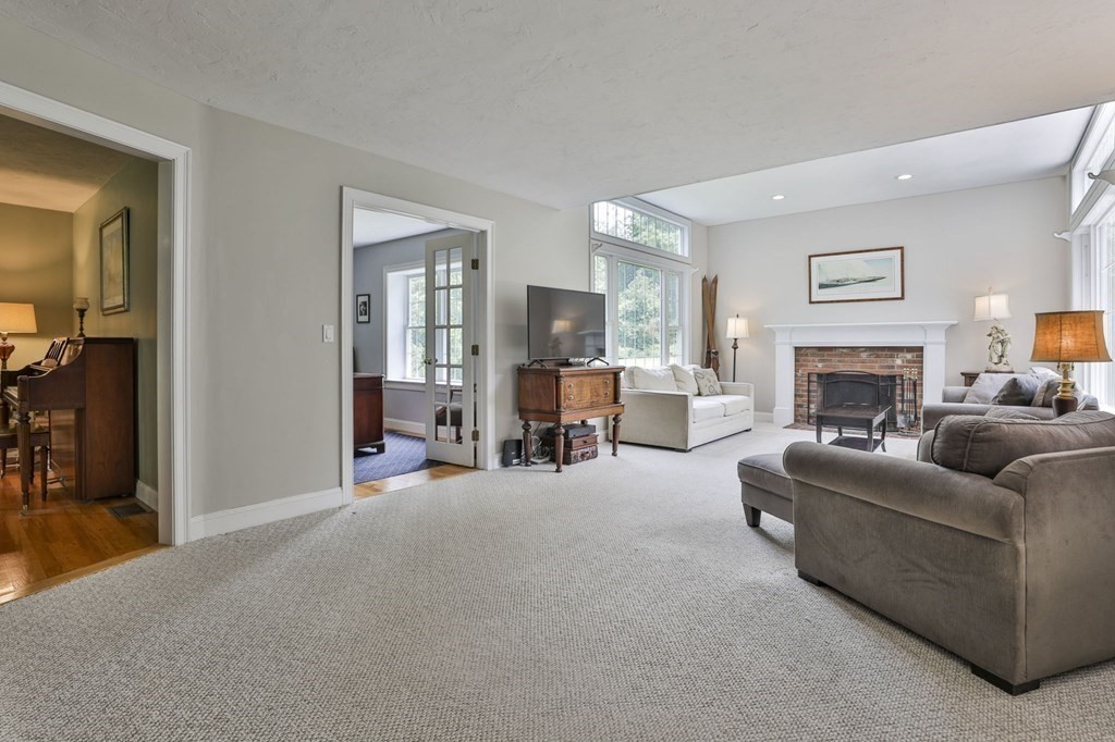4 Breezy Point Road Acton, MA 01720 - Photo 11 of 40 a living room with furniture and a fireplace