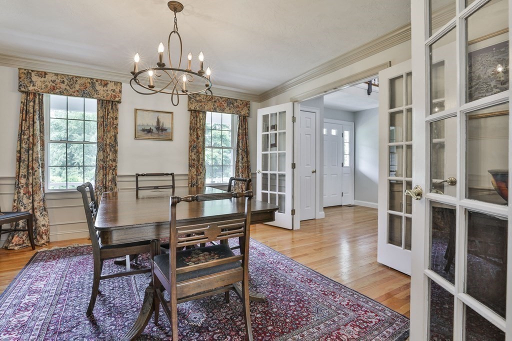 4 Breezy Point Road Acton, MA 01720 - Photo 14 of 40 a living room with furniture a rug and a chandelier