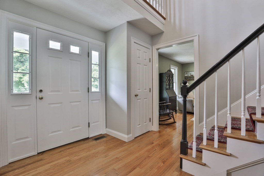 4 Breezy Point Road Acton, MA 01720 - Photo 20 of 40 a view of entryway with wooden floor and stairs
