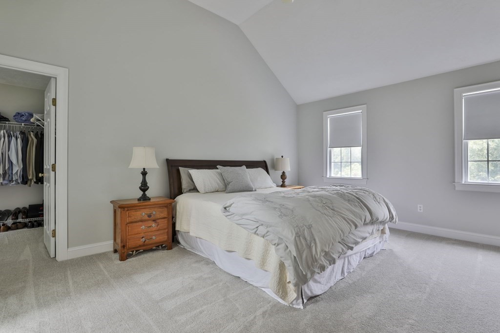 4 Breezy Point Road Acton, MA 01720 - Photo 25 of 40 a spacious bedroom with a bed and a window