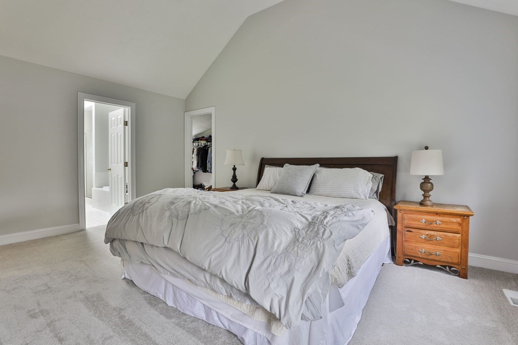 4 Breezy Point Road Acton, MA 01720 - Photo 26 of 40 a bedroom with a bed and lamp