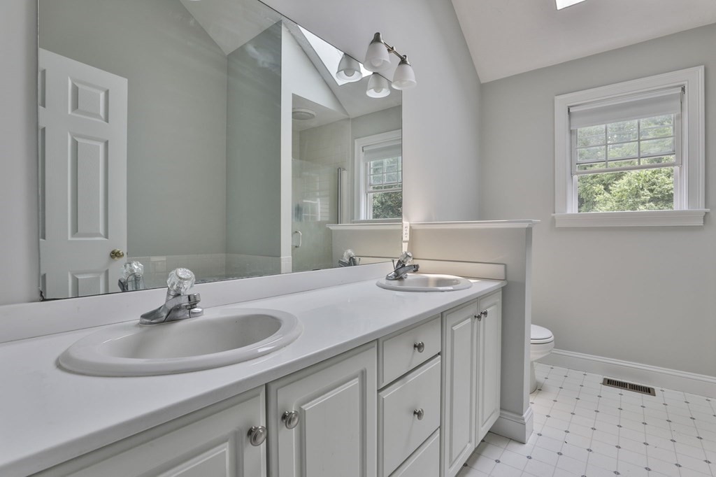 4 Breezy Point Road Acton, MA 01720 - Photo 28 of 40 a bathroom with a sink and a mirror