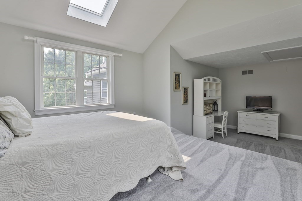 4 Breezy Point Road Acton, MA 01720 - Photo 32 of 40 a bedroom with a bed and a flat screen tv