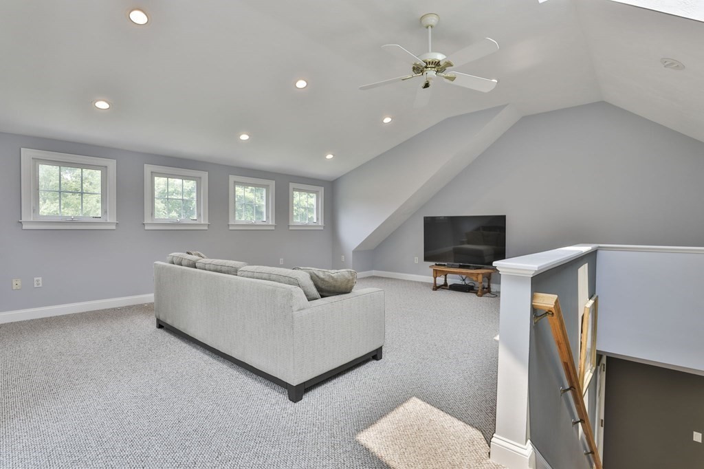 4 Breezy Point Road Acton, MA 01720 - Photo 36 of 40 a living room with furniture and a flat screen tv