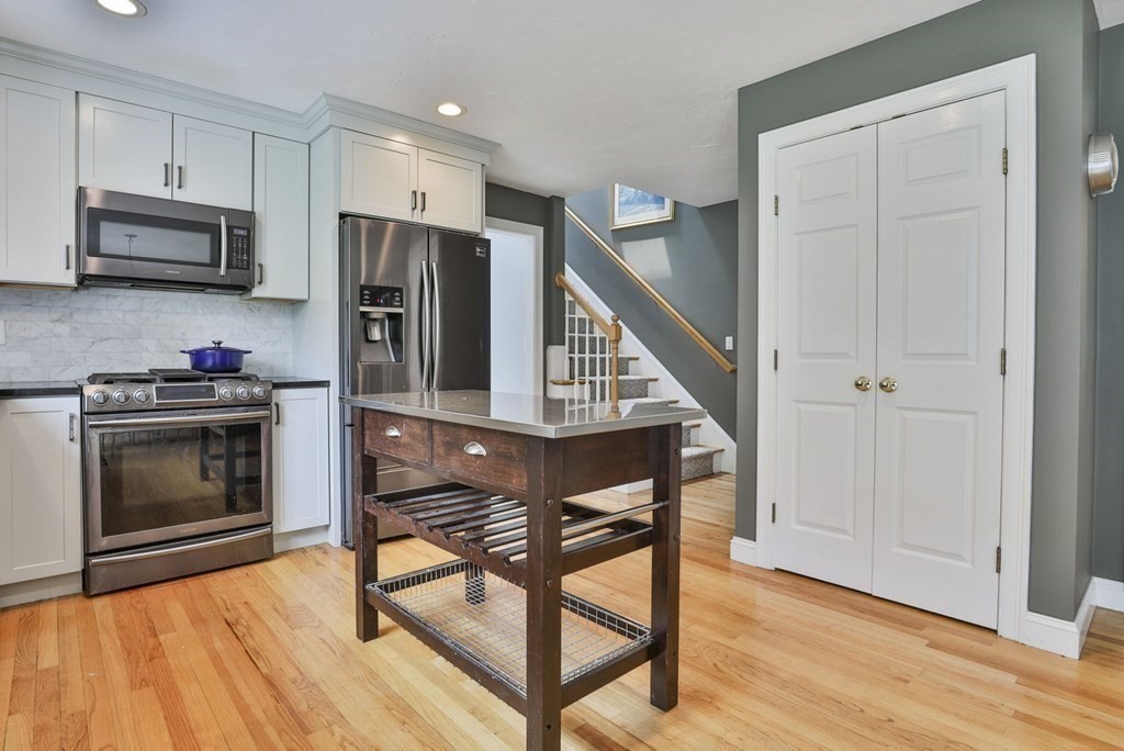 4 Breezy Point Road Acton, MA 01720 - Photo 6 of 40 a kitchen with stainless steel appliances a stove a microwave and cabinets