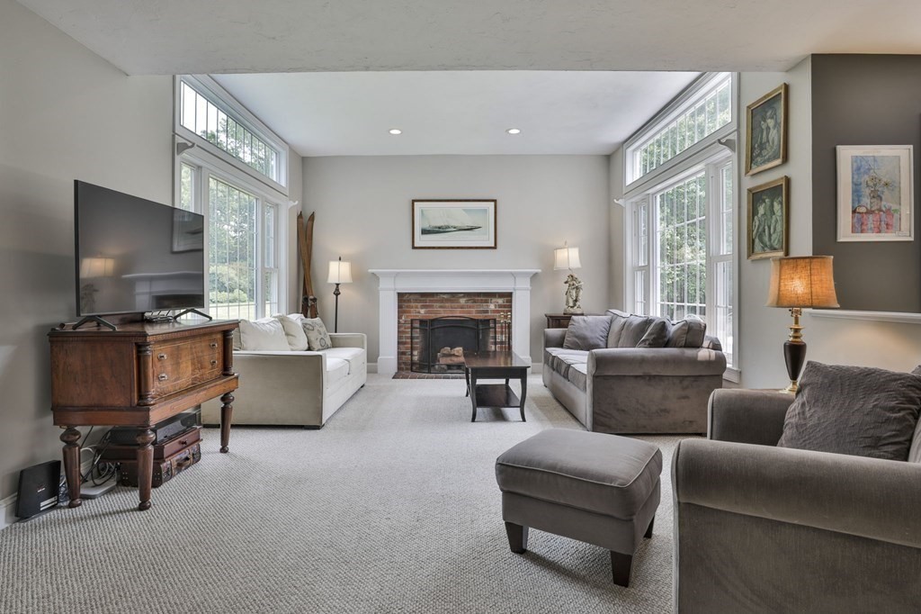 4 Breezy Point Road Acton, MA 01720 - Photo 10 of 40 a living room with furniture and a flat screen tv