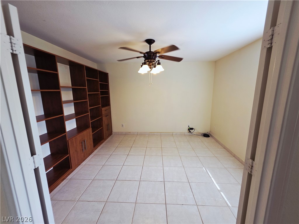 2920 Setting Sun Street Las Vegas, NV 89117 - Photo 35 of 43 This versatile room features expansive built-in shelving, perfect for a library or home office.