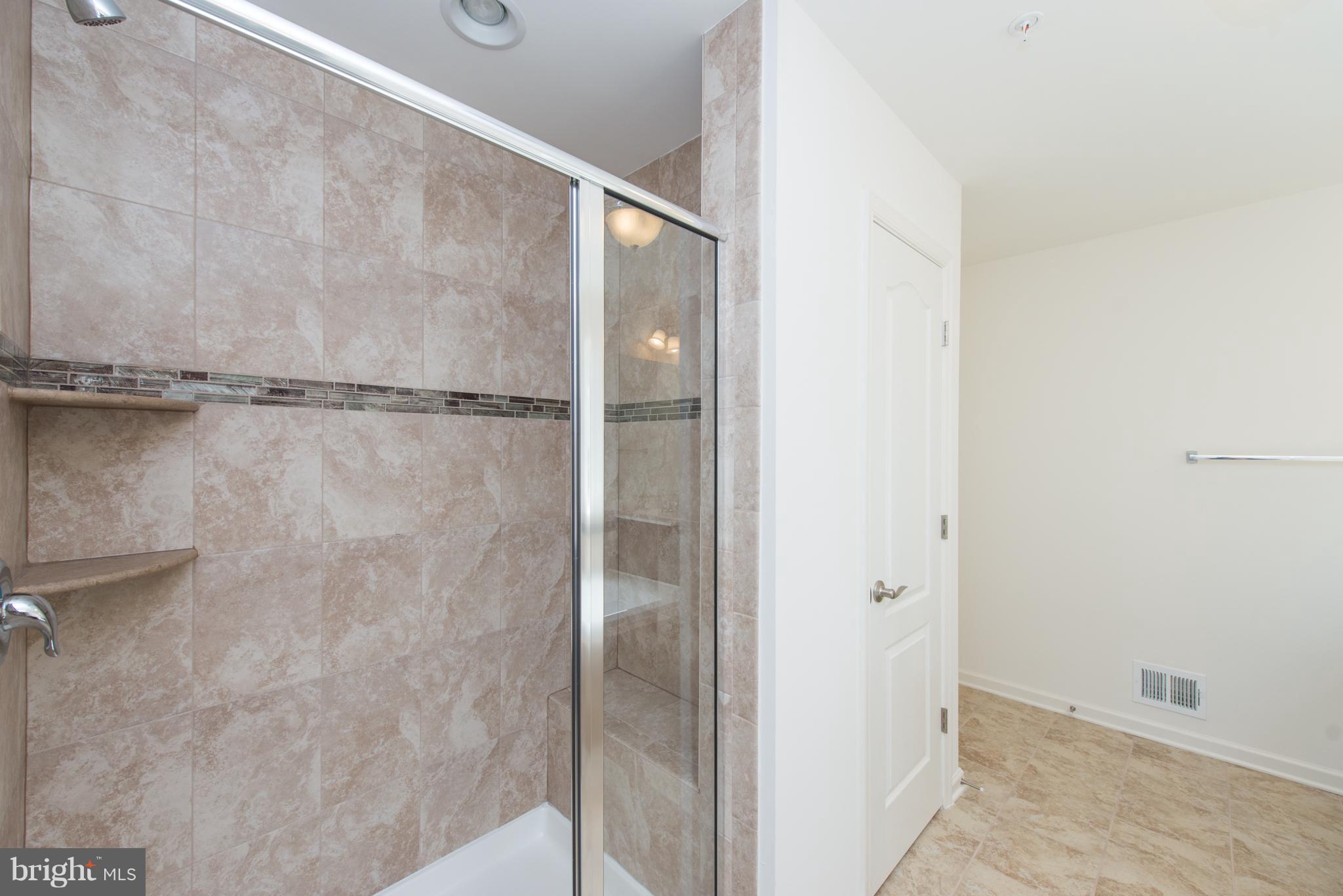 910 Ramble Run Road Baltimore, MD 21220 - Photo 26 of 30 a bathroom with a glass shower door