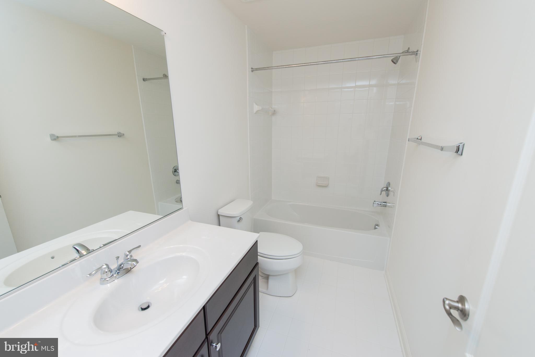 910 Ramble Run Road Baltimore, MD 21220 - Photo 27 of 30 a bathroom with a sink a toilet and shower