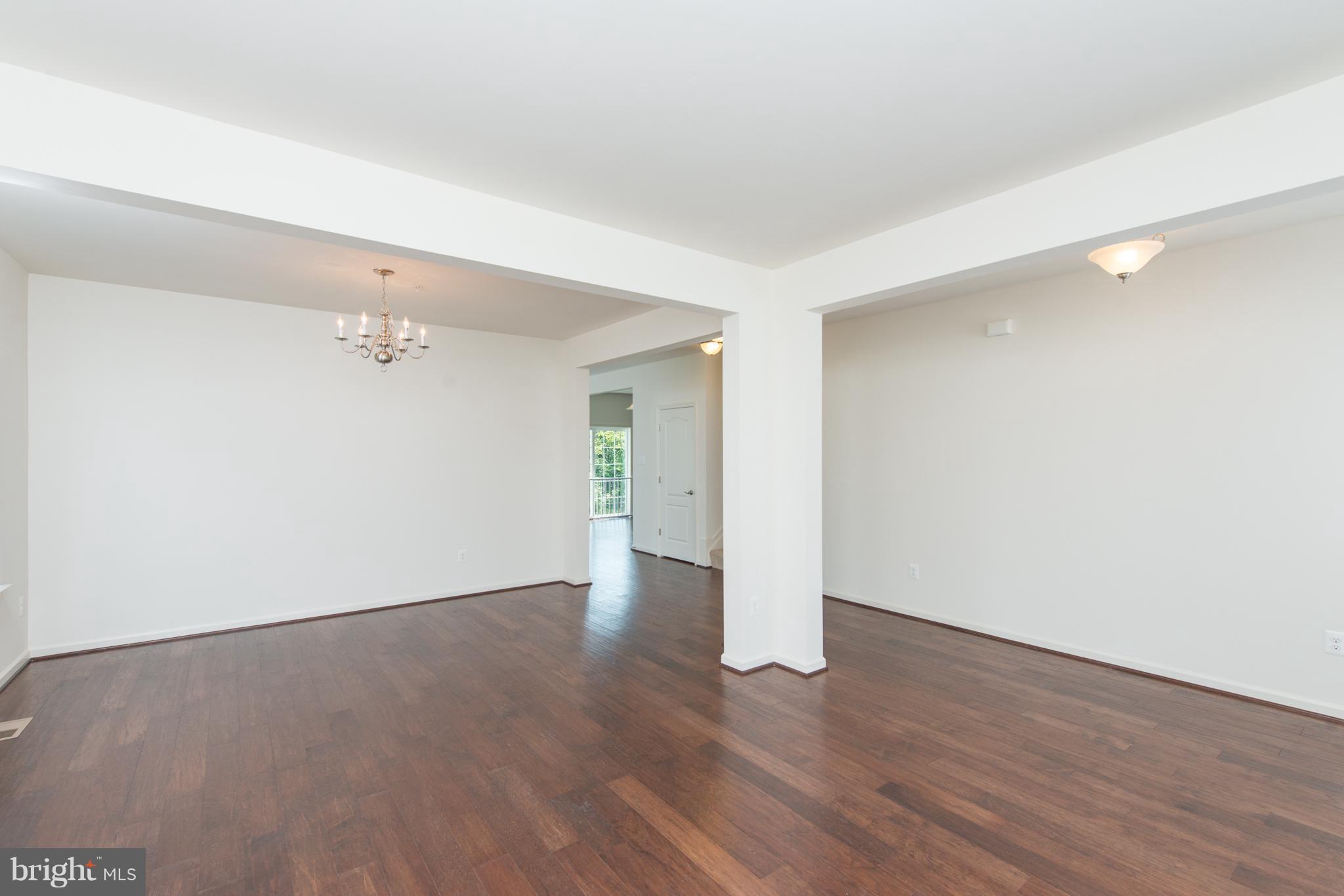 910 Ramble Run Road Baltimore, MD 21220 - Photo 5 of 30 a view of an empty room with wooden floor