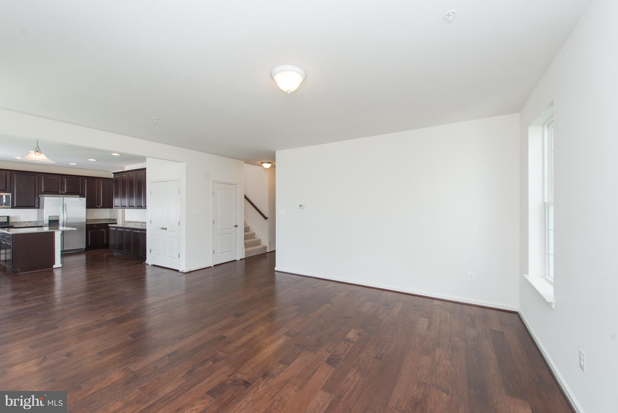 910 Ramble Run Road Baltimore, MD 21220 - Photo 8 of 30 a view of a kitchen with wooden floor and a sink