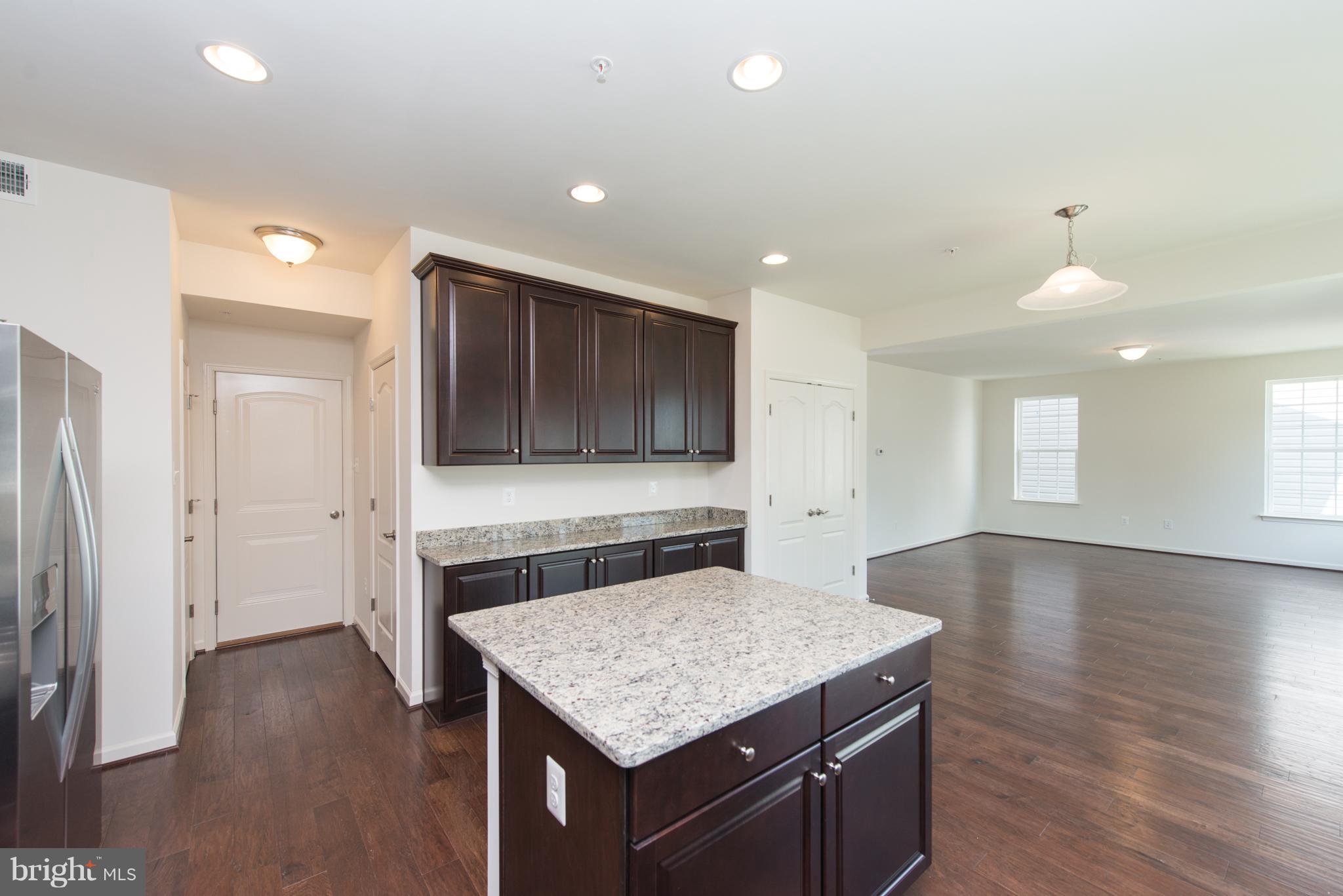 910 Ramble Run Road Baltimore, MD 21220 - Photo 10 of 30 a kitchen with a stove and a wooden floor