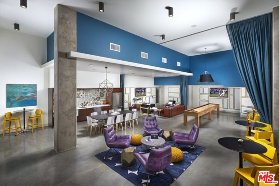 1120 West 6th Street, Unit 2151 Los Angeles, CA 90017 - Photo 13 of 51 a living room with furniture and a flat screen tv