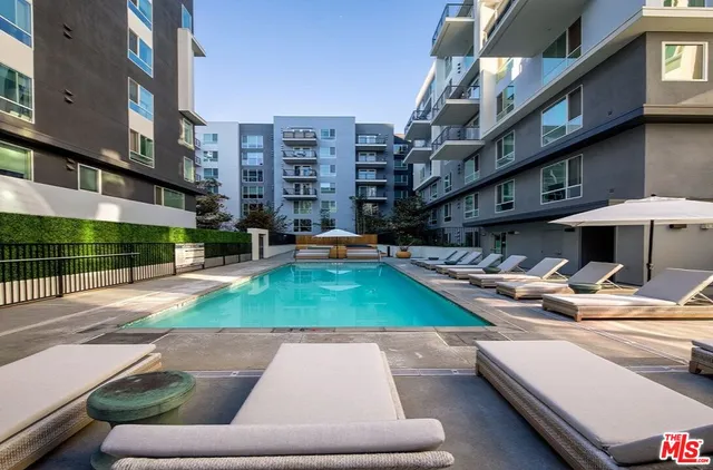 a swimming pool with outdoor seating and yard