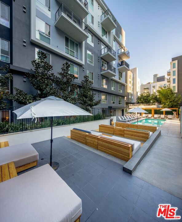 1120 West 6th Street, Unit 2151 Los Angeles, CA 90017 - Photo 32 of 51 a swimming pool with outdoor seating and yard