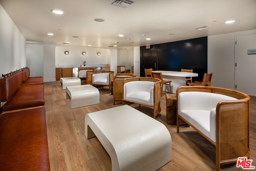 1120 West 6th Street, Unit 2151 Los Angeles, CA 90017 - Photo 40 of 51 a living room with couches a flat screen tv and kitchen view