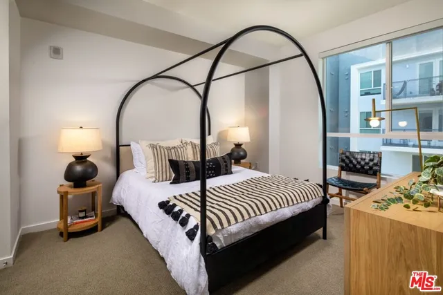 a bed room with a bed and a mirror