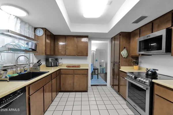 a kitchen with stainless steel appliances a stove sink microwave and cabinets