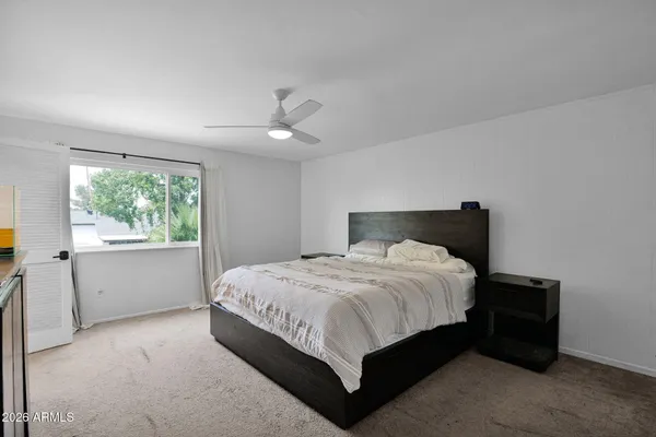 a bedroom with a bed and window