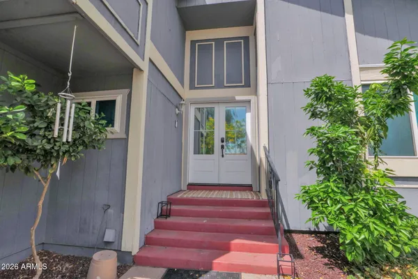 a view of a house with potted plants