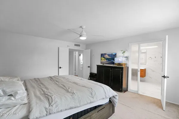 a bedroom with a bed and a television