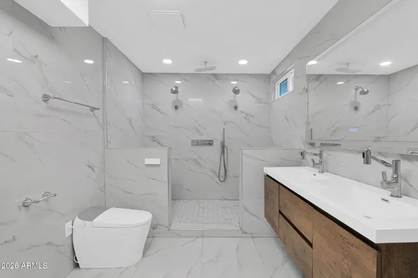 a bathroom with a toilet sink and shower