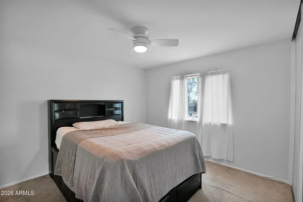 a bedroom with a bed and window