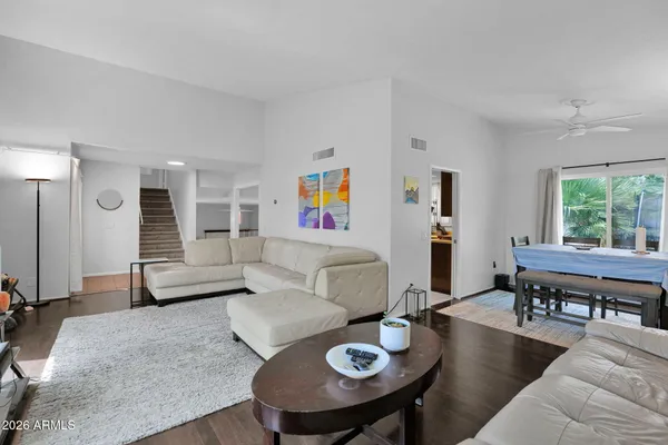 a living room with furniture and a wooden floor