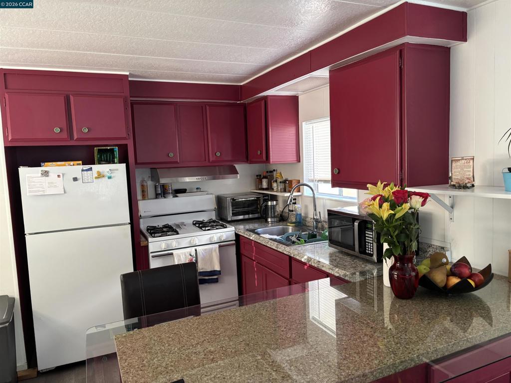 2990 San Pablo Dam Road San Pablo, CA 94803 - Photo 4 of 13 a kitchen with refrigerator cabinets and wooden floor