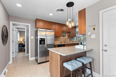 a kitchen with refrigerator and cabinets