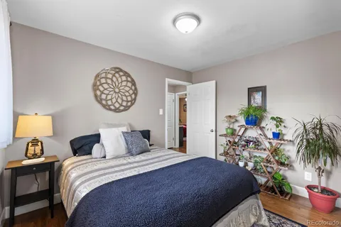 a bedroom with a bed and a potted plant