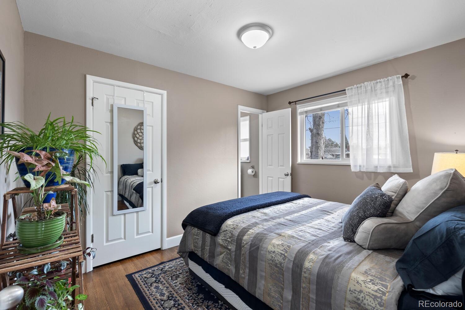 236 Lima Street Aurora, CO 80010 - Photo 18 of 50 a bedroom with a bed a flat screen tv and a window