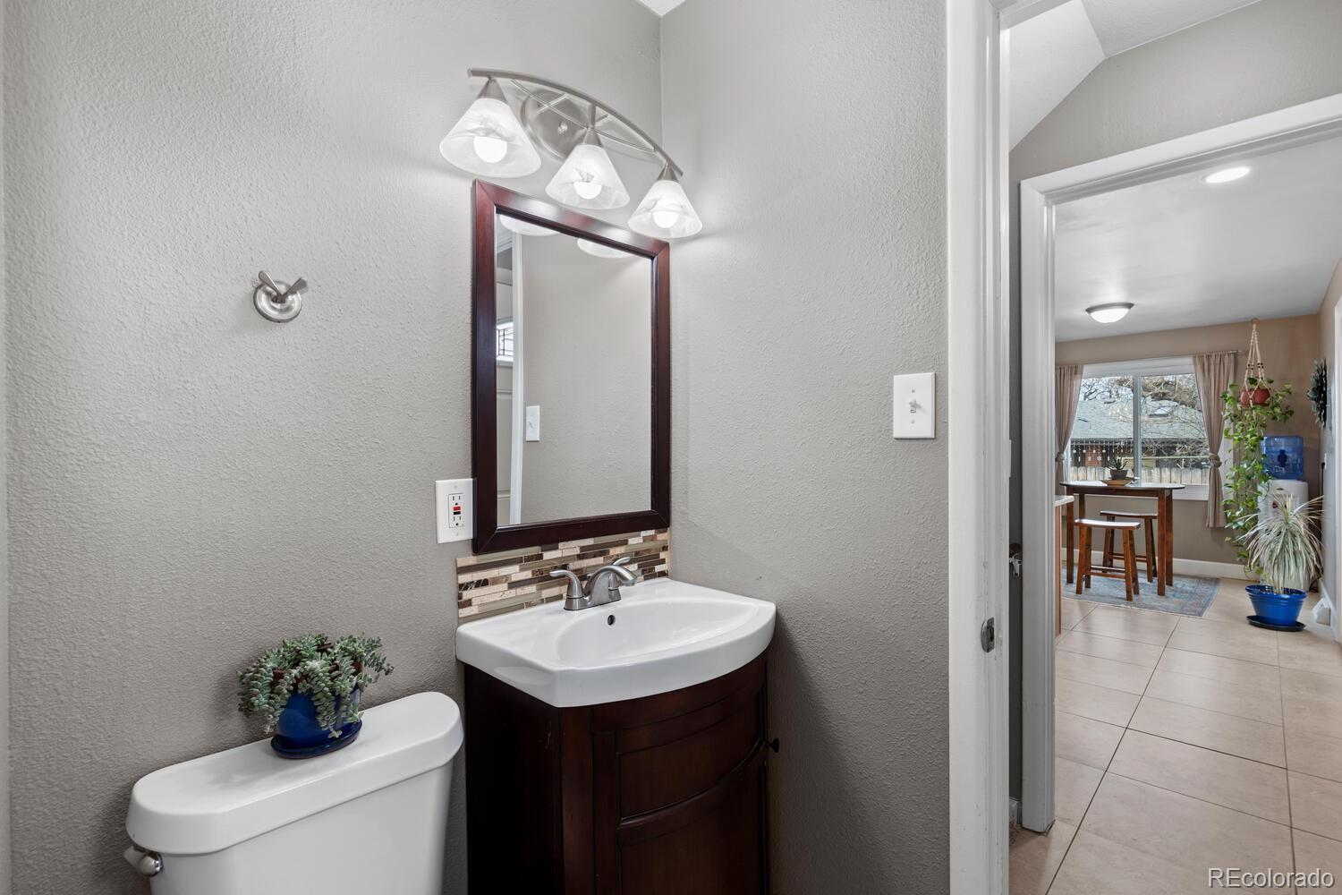 236 Lima Street Aurora, CO 80010 - Photo 19 of 50 a bathroom with a sink and a mirror